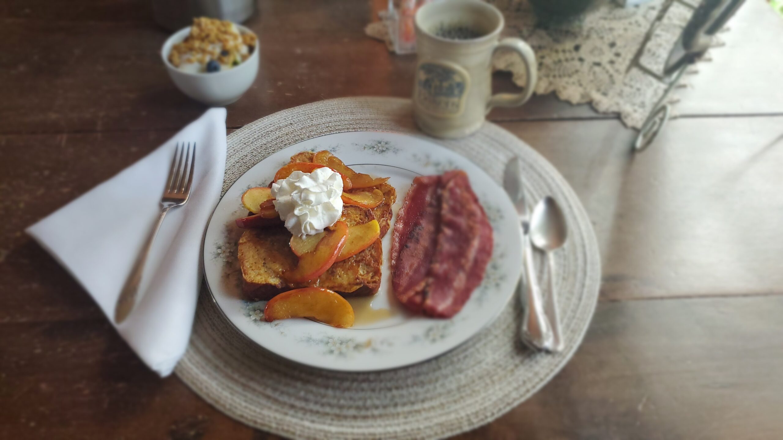 Beige guest room, bed with rustic headboard and quilt, and two small nightstands,.